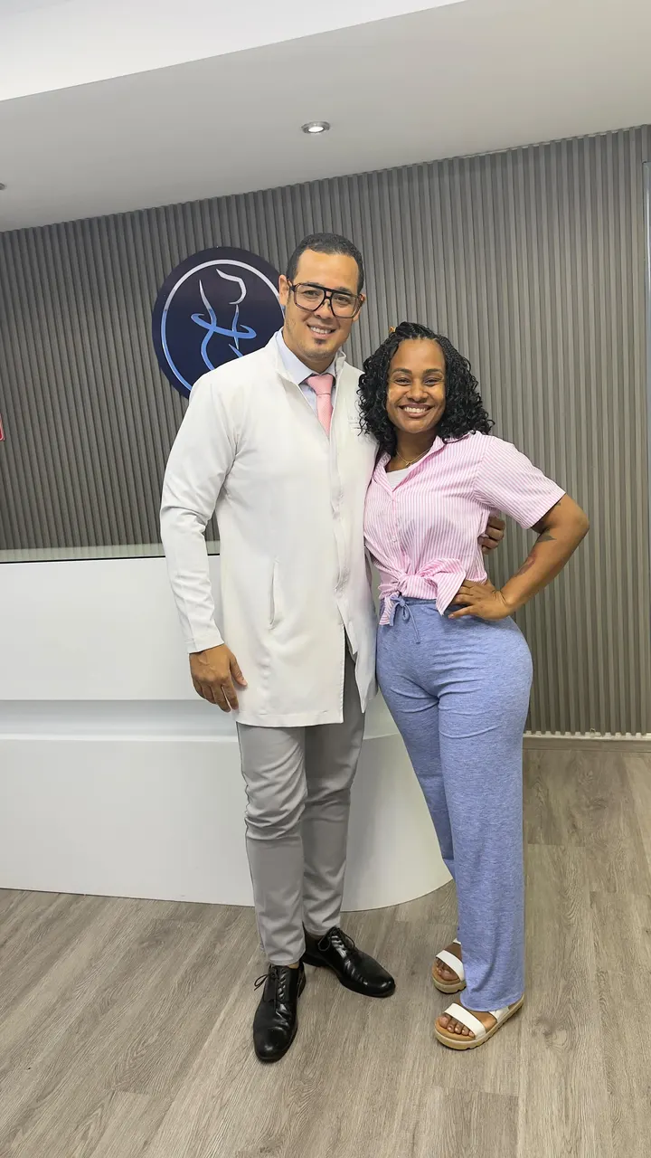 Dr. José Miguel Díaz, in a white coat, with a patient at the Plasthetic clinic in Gazcue, Santo Domingo.